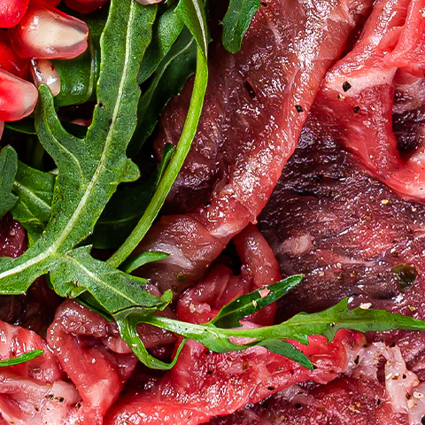 carpaccio-marbled-beef-meat-with-arugula-and-pomeg-2024-12-10-00-28-16-utc